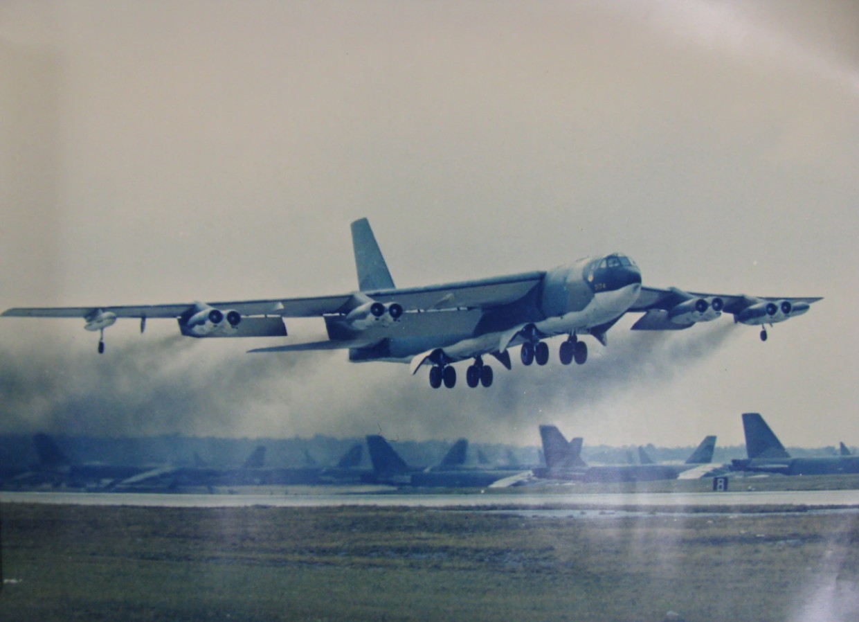 Two Tu-95 Bear bomber aircraft, center, and an AN-124 Condor transport  aircraft of the Russian military, background, are parked on the flight line  beside a B-52H Stratofortress aircraft of the 62nd Bombardment